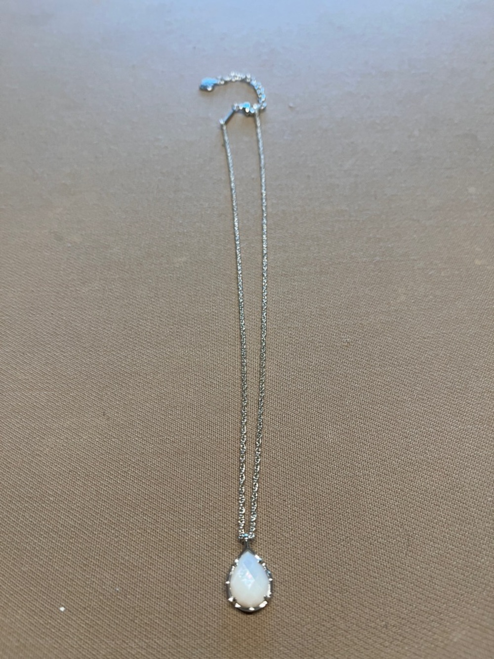 Kendra Scott necklace with ivory colored stone.